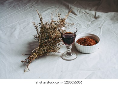 Thyme Bouquet, Shot Glass Of Chokeberry Tree Liqueur And Rooibos (redbush) Tea In A Bowl On A Flax Linen Cloth Table Background 