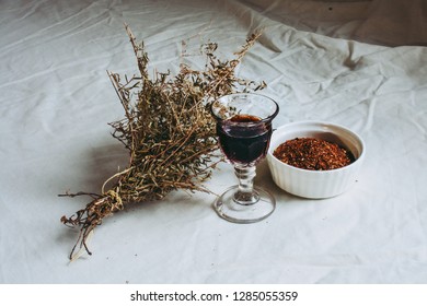 Thyme Bouquet, Shot Glass Of Chokeberry Tree Liqueur And Rooibos (redbush) Tea In A Bowl On A Flax Linen Cloth Table Background 