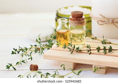 Thyme essential oil. Bottles with extract, fresh green plant leaves. Aromatherapy treatment.