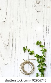 Thyme and string over rustic distressed timber background.  Lots of copy space.