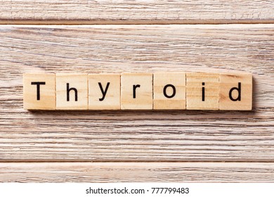 Thyroid word written on wood block. Thyroid text on table, concept.