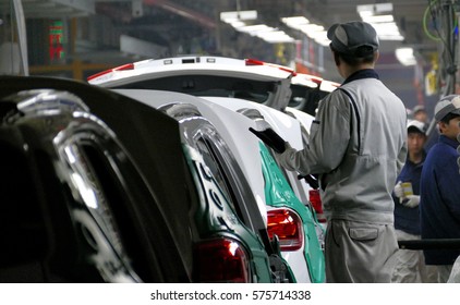 Tianjin, China. December 17th 2016: Workers assemble a car on assembly line in car factory