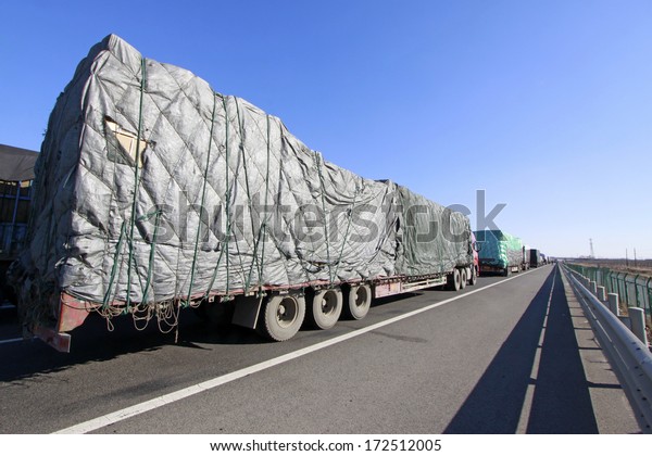TIANJIN - DECEMBER 9: heavy duty trucks stopped on the\
highway Because of the traffic jam, on December 9, 2013, tianjin,\
China.  