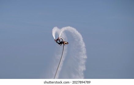 Tianjin,China-Aug 18,2021: An Artist Is Performing  Flying Trapeze Show On The Sea.