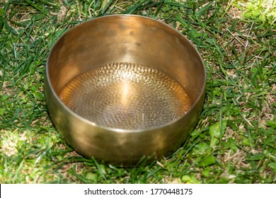 Tibetan Bell With Water Inside That Ripples With The Sound Waves Emitted After Percussion With The Special Wooden Instrument