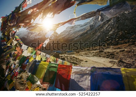 Tibetan Flags on Annapurna Base Camp in Nepal, Himalaya. Sunrise above Machapuchare mountain