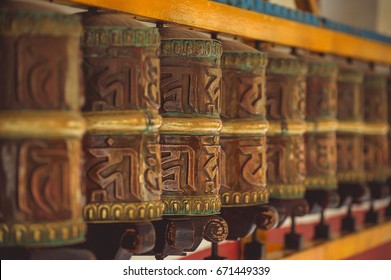 Tibetan metal prayer wheels with mantras at Manali.