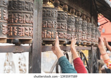 Tibetan prayer wheels at Swayambhunath, Nepal. Text translation: The magic symbol power of buddhism for prayer get divine blessings and good fortune.