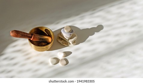 Tibetian singing bowl, stone pyramid, stones, with sunlight abstract background, relaxing concept. Top view, copy space.