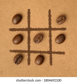 Tic Tac Toe Coffee Beans On Paper Background. Macro, Flat Lay.