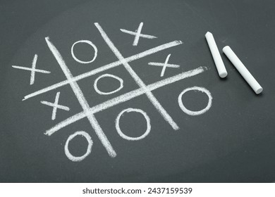 Tic tac toe game drawn on chalkboard - Powered by Shutterstock