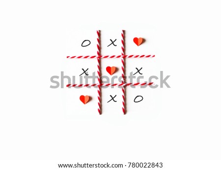 Tic tac toe game or noughts and crosses.  Red heart shaped and grid line made from paper cut,red-white rope.Flat lay,top view and white isolated.Minimal love concept.Copy space for text.Easy to use.