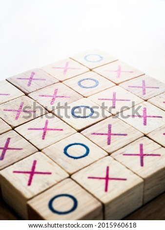 Tic tac toe, ox game board made by wooden block isolated on white background, vertical style.