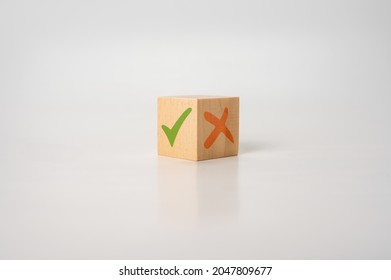 Tick mark and cross mark x on wooden cubes. pros and cons concept. Wooden cube with image of pros versus cons. Concept of positive or negative decision making or choice of approval or rejection. - Shutterstock ID 2047809677