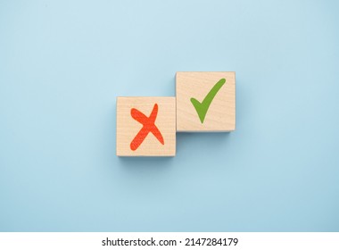 Tick mark and cross mark x on wooden cubes. Concept of positive or negative decision making or choice of approval or rejection. chooses checkmark and x sign symbol on wooden cube block. blue - Shutterstock ID 2147284179