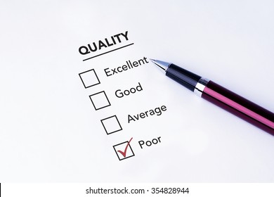 Tick placed in poor check box on quality service satisfaction survey form with a pen on isolated white background. Business concept survey.