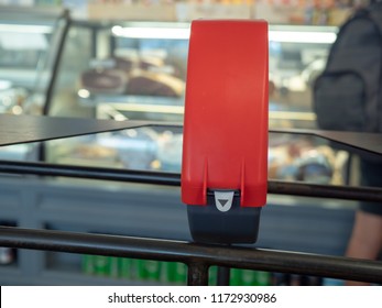 A Ticket Dispenser Sitting In Front Of Line At A Local Deli Counter With Man In Back