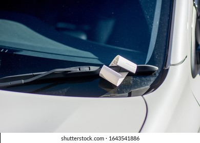 Ticket For Illegal Parking Issued By Australian Parking Ranger On A Windscreen Of A White Car