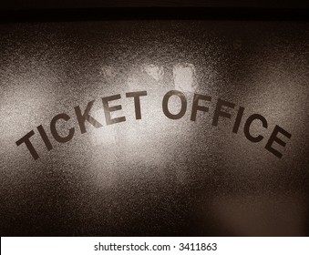 Ticket Office lettering sign on a privacy glass window in a sales counter office in nostalgic sepia