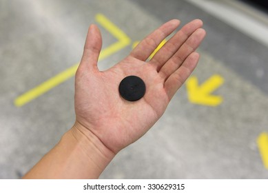 Ticket On Male Hand  In Subway, MRT Single Journey Token, The Way Into For Train On Platform