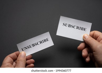 tickets with the word subscribe and unsubscribe in the hands of a man. The concept of choice.