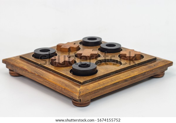 The Tic-tac-toe, noughts, and crosses,  Xs\
and Os wooden game board. Often used as a pedagogical tool for\
teaching the concepts of good sportsmanship and the branch of\
artificial intelligence.