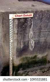 Tide Gauge Or Tide Staff On A Harbour Wall, Showing Chart Datum, Used By Boats To Determine Water Depth.