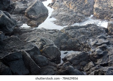 Tide Pools On Black Volcanic Rock In The Kona District Of Hawaii