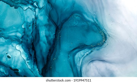 Tidewater alcohol stains of paint with the addition of gold powder. Subtle waves of paint, abstract blue waves of the ocean, lines of marble. Liquid paints, gradient stains, painting. Tinting Tidewate - Shutterstock ID 1919947511