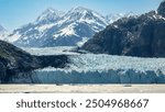 Tidewater terminus of Margerie Glacier, a World Heritage site, the largest glacier in Glacier Bay National Park and Preserve, with a view of mountains in the area, mid afternoon in southeastern Alaska