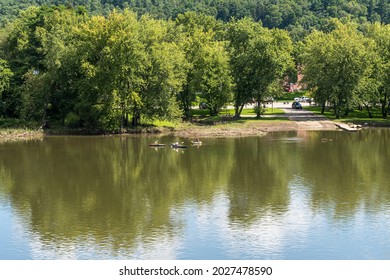 Tidioute, Pennsylvania, USA August 1, 2021 Three People Kayaking On The Allegheny River In Front Of The Tidioute Boat Ramp On A Sunny Summer Day