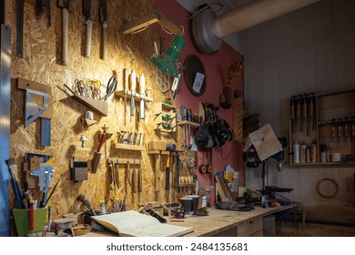 Tidy clean carpenter workplace with various woodworking tools. Comfortable, well-refreshed workspace with huge variety of work accessories, supplies. Arranged place for joiner artisan to work.