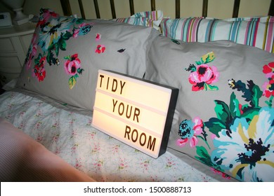 Tidy Your Room Letter Light Box On A Well Made Bed With Floral Pillows