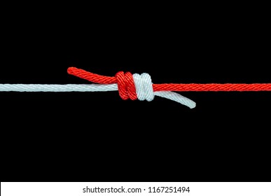 Tie the knot with red and white rope on black background, with clipping path - Powered by Shutterstock