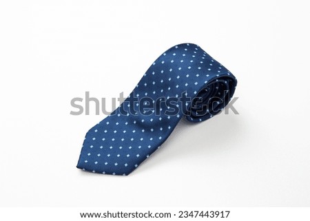 A tie with a polka dot pattern on a white background.