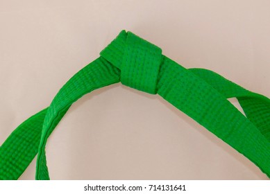 Tied Martial Arts Green Belt Isolated On An Off-white Background