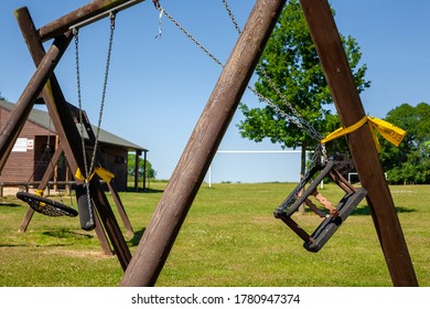 Tied Up Swing Set In Park During Full Lockdown In Hampshire, England. Pandemic Prevention Restricted Lockdown Covid-19.