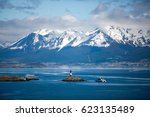 Tierra del Fuego,  landscape of snowy and wooded mountains and ocean