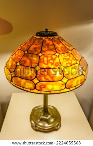Tiffany table lamp with bright orange shade
