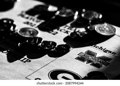 Tiffin, Iowa, USA - 12.2022 - Selective Focus On 2021-2022 College Football Playoff Bracket With Scattered Coins.