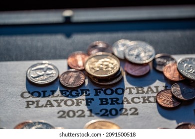 Tiffin, Iowa, USA - 12.2022 - Selective Focus On 2021-2022 College Football Playoff Bracket With Scattered Coins.