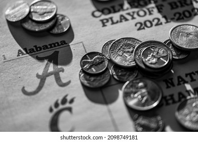 Tiffin, Iowa, USA - 12.2022 - Selective Focus On 2021-2022 College Football Playoff Bracket With Scattered Coins.