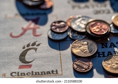 Tiffin, Iowa, USA - 12.2022 - Selective Focus On 2021-2022 College Football Playoff Bracket With Scattered Coins.