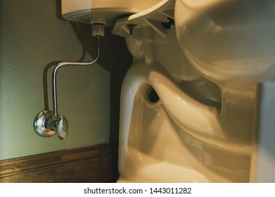 Tiffin, Iowa, USA - 6/2019: residential toilet water shutoff valve