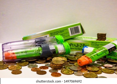 Tiffin, Iowa, USA - 8/2019:   EpiPen (an Epinephrine Injector) On Top Of A Pile Of Coins