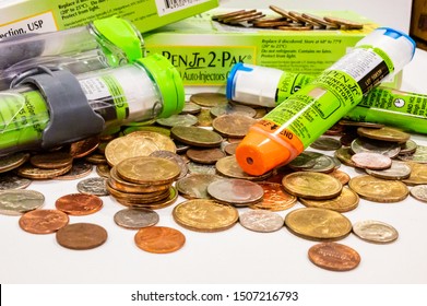 Tiffin, Iowa, USA - 8/2019:   EpiPen (an Epinephrine Injector) On Top Of A Pile Of Coins