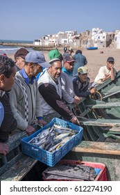 TIFNIT, SOUSS-MASSA, MOROCCO - MARCH 02, 2016: Group of fishermen auctioning fishing, on the village beach