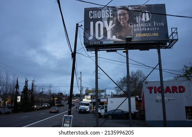 Tigard, OR, USA - Dec 23, 2021: A billboard advertising George Fox University's counseling degree programs is seen along the SW Pacific Highway in Tigard, Oregon, in the evening.