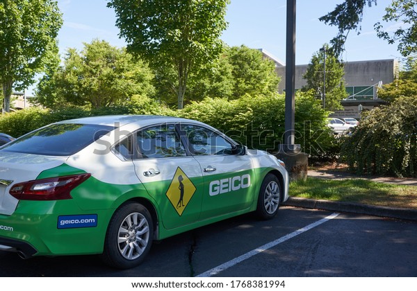 Tigard, OR, USA - Jun 23, 2020: A Geico branded\
car is seen parked on the street in Tigard, Oregon. The Government\
Employees Insurance Company is an American auto insurance company\
based in Maryland.