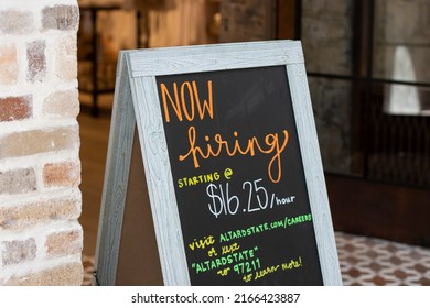 Tigard, OR, USA - May 31, 2022: Now Hiring Sign Showing Promised Minimum Hourly Wage Is Seen At The Entrance To An Altar'd State Retail Store In Washington Square Shopping Mall In Tigard, Oregon.